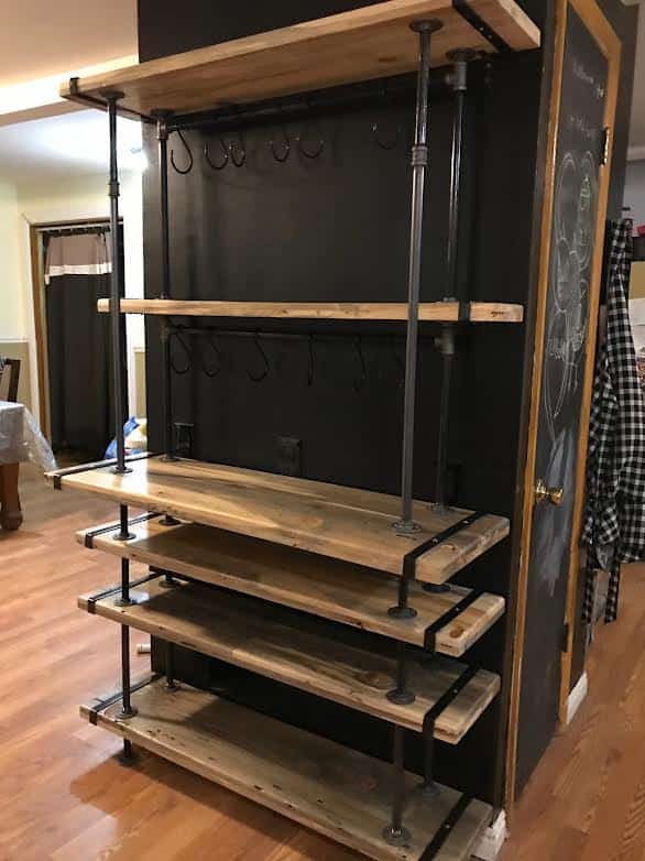 a wood shelf with metal pipes
About Us